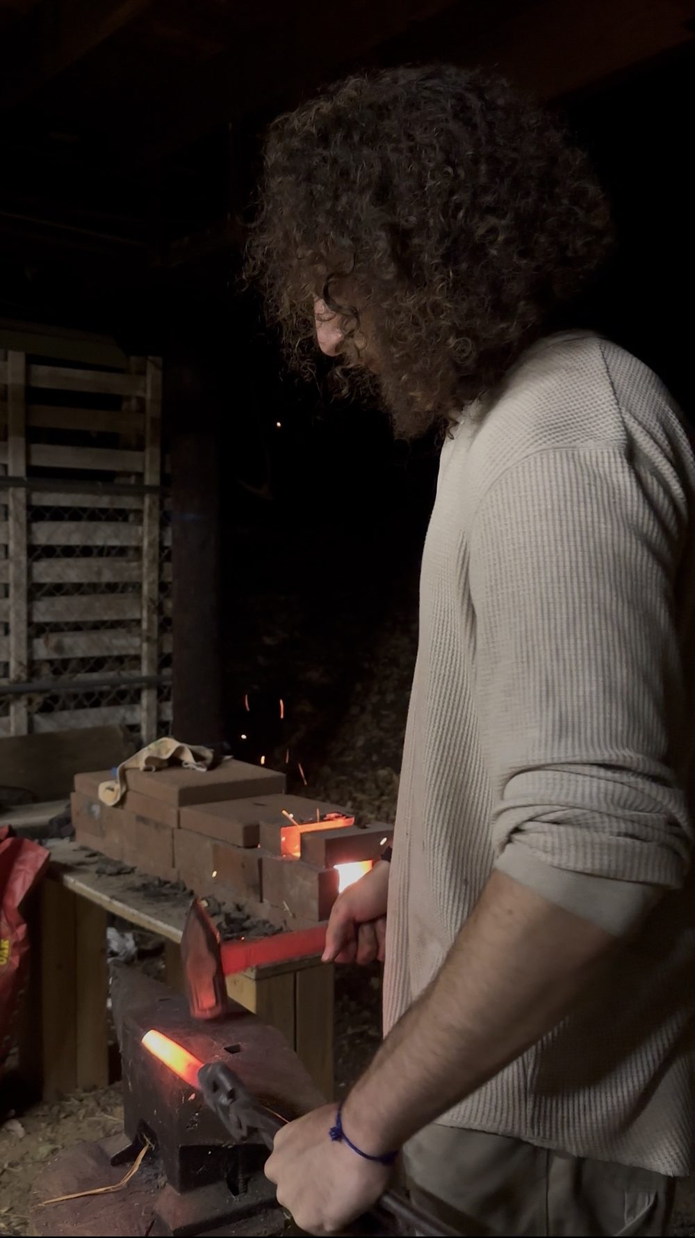 Hamza working hot steel at the forge